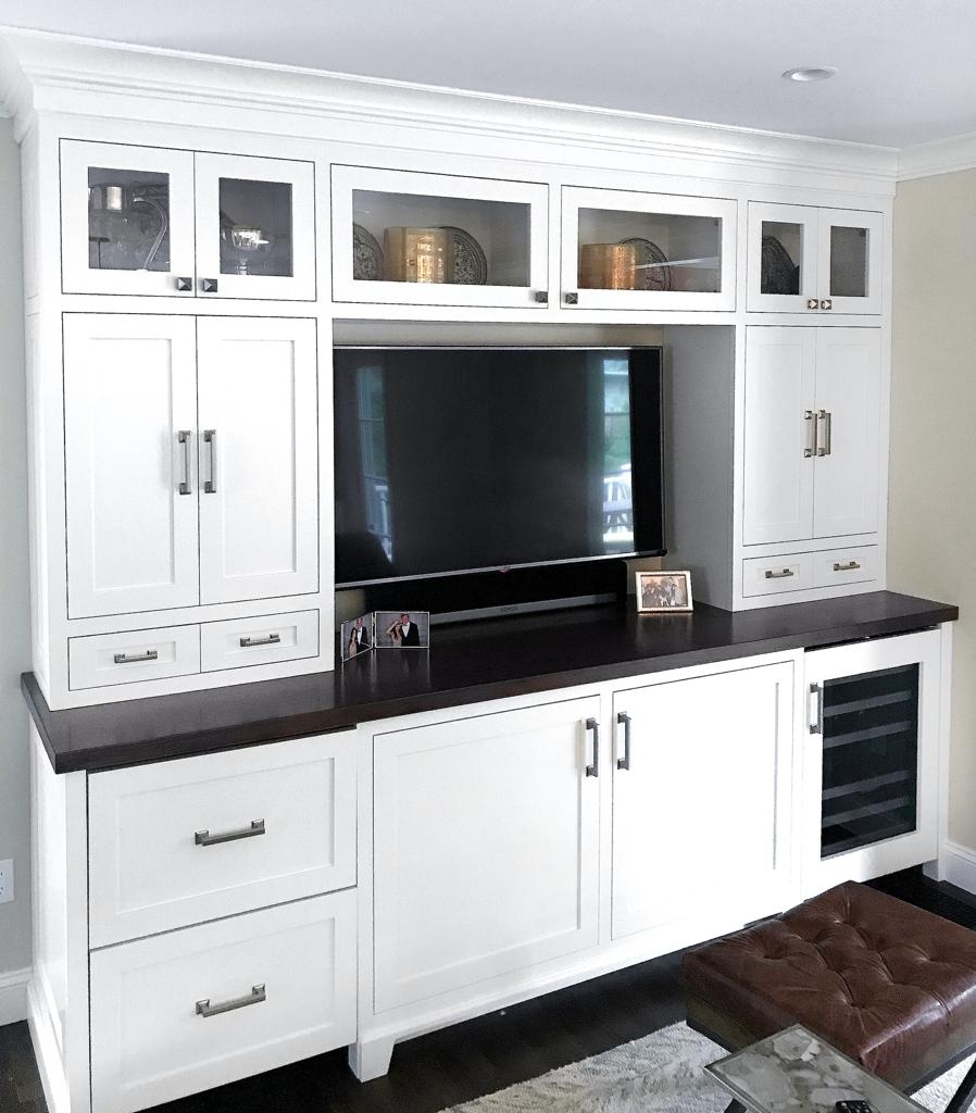 Sophisticated living room media wall with smoked timber slats, hidden cable chase management